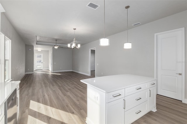 kitchen with pendant lighting, white cabinetry, a center island, and light wood-type flooring