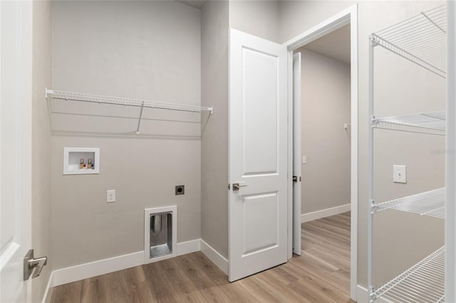 washroom with light hardwood / wood-style floors, hookup for a washing machine, and hookup for an electric dryer