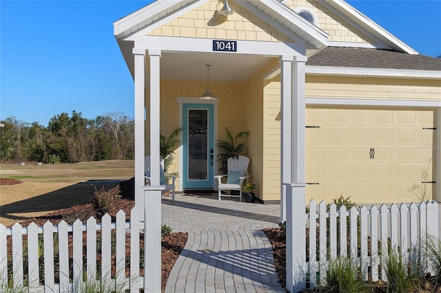 view of exterior entry with a garage