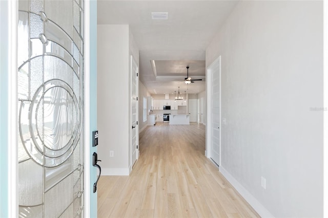 foyer entrance with light hardwood / wood-style flooring and ceiling fan