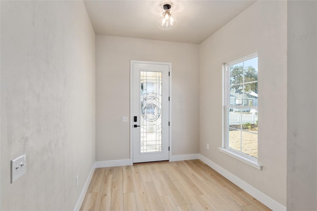 entrance foyer with a wealth of natural light and light wood-type flooring