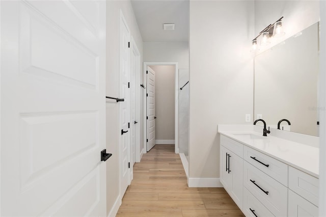 bathroom with hardwood / wood-style flooring and vanity