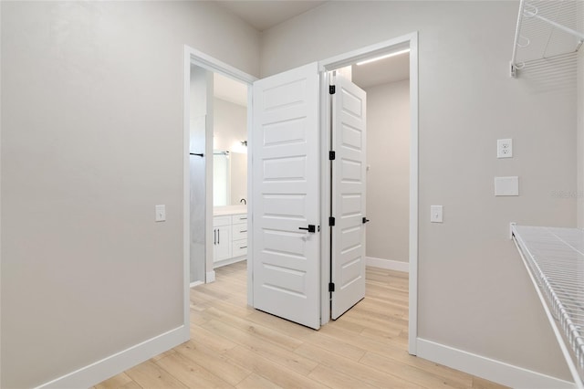 hallway with light hardwood / wood-style flooring