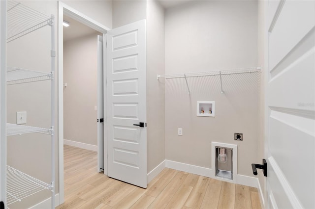 laundry room featuring hookup for a washing machine, hookup for an electric dryer, and light wood-type flooring