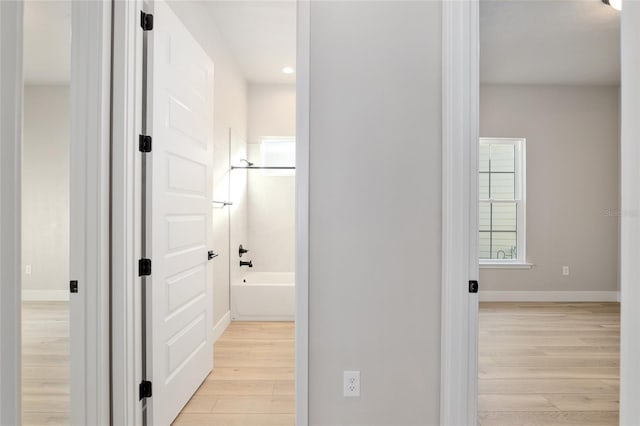 hallway with light hardwood / wood-style flooring