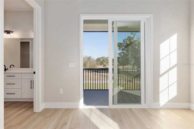 doorway to outside with light wood-type flooring