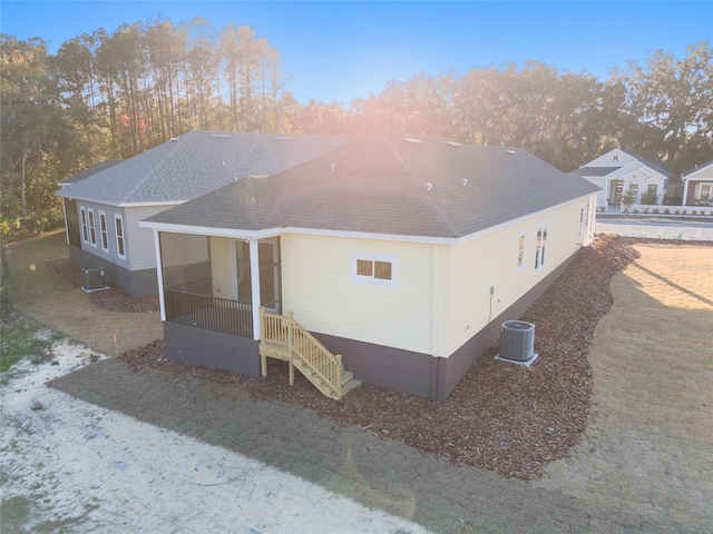 rear view of house with central AC unit