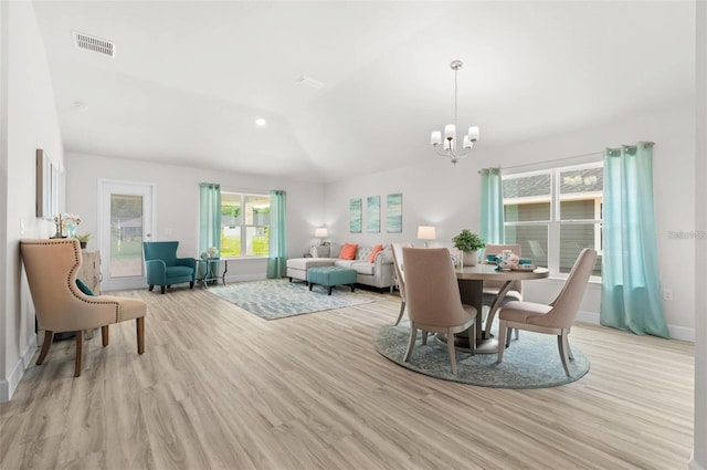 dining area featuring light hardwood / wood-style floors and an inviting chandelier