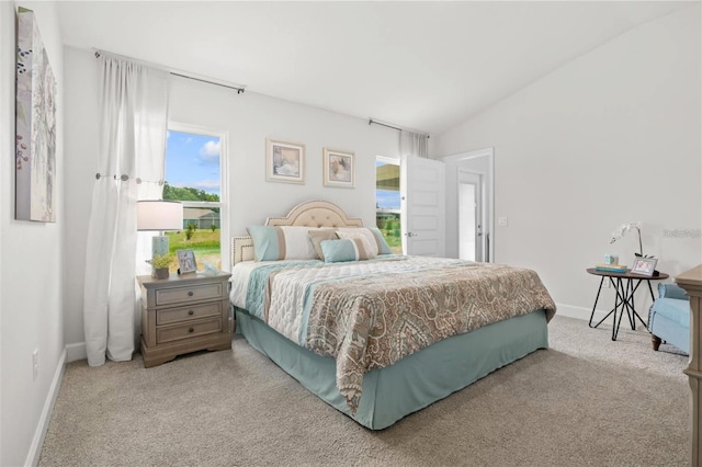 carpeted bedroom featuring vaulted ceiling