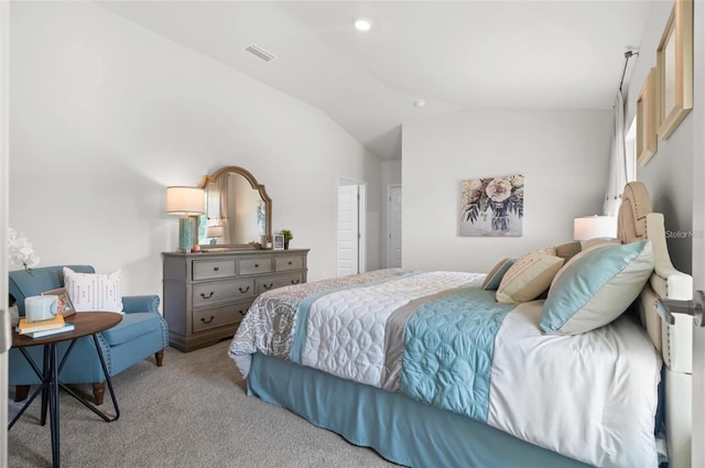 carpeted bedroom with lofted ceiling