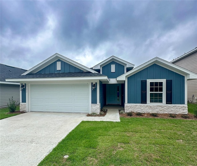 view of front of property with a front yard and a garage