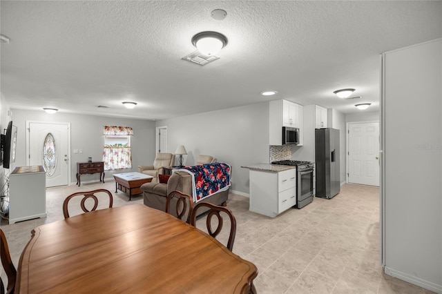 dining area featuring a textured ceiling