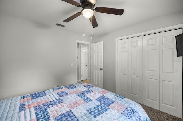 bedroom featuring ceiling fan, a closet, and carpet