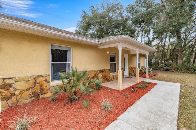 entrance to property featuring a patio