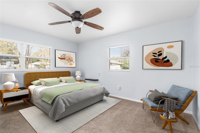 bedroom with ceiling fan, carpet floors, and multiple windows