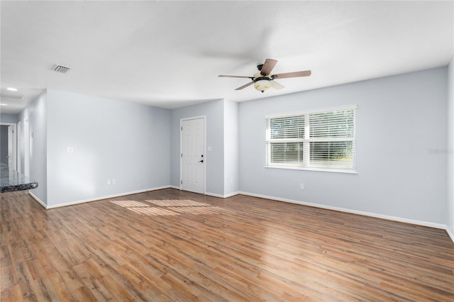 empty room featuring ceiling fan and light hardwood / wood-style flooring