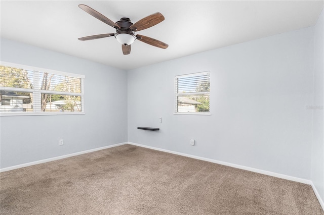 spare room featuring ceiling fan, a healthy amount of sunlight, and carpet floors