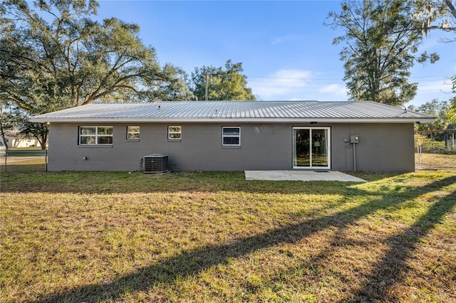 rear view of house featuring a patio area, cooling unit, and a yard