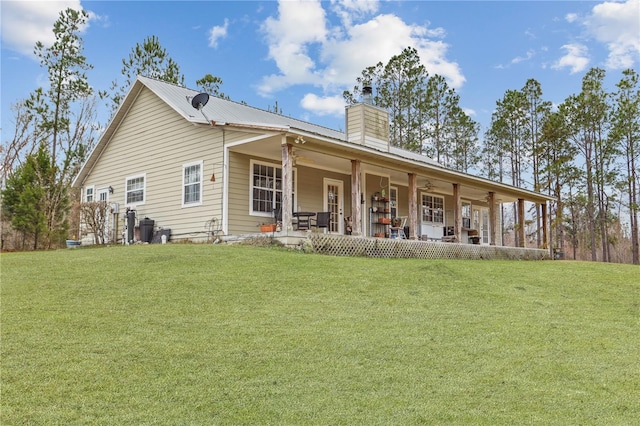 back of house with a yard and a porch