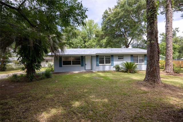 ranch-style home with a front lawn