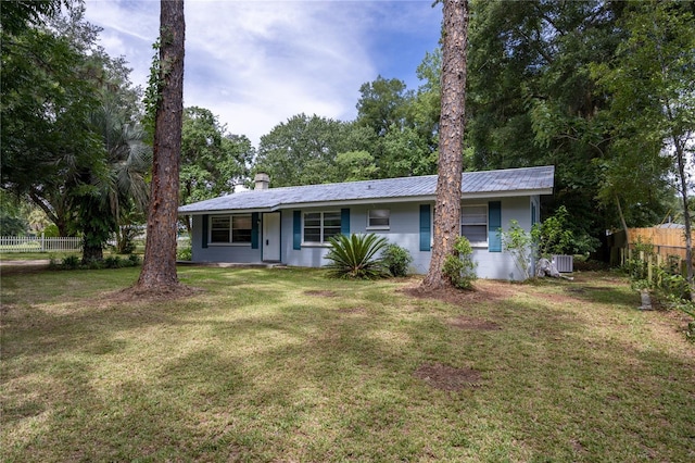 ranch-style home featuring a front lawn and cooling unit