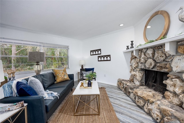 living room featuring crown molding, a fireplace, and hardwood / wood-style flooring