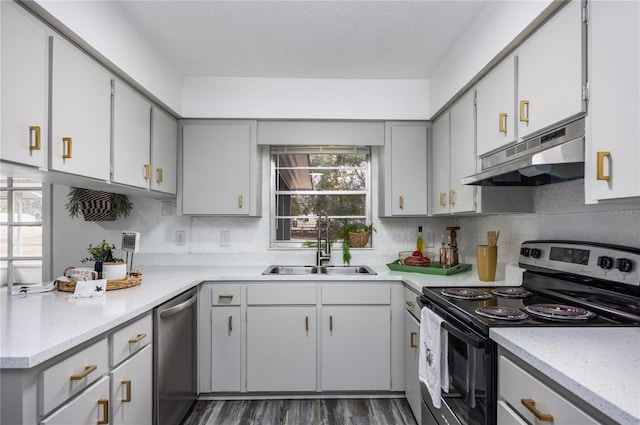 kitchen featuring dishwasher, electric range oven, sink, a textured ceiling, and dark hardwood / wood-style flooring