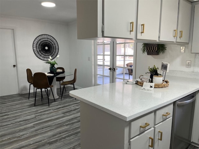 kitchen featuring stainless steel dishwasher, kitchen peninsula, crown molding, french doors, and dark hardwood / wood-style flooring