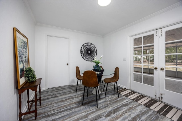 dining room featuring dark hardwood / wood-style flooring, crown molding, and french doors