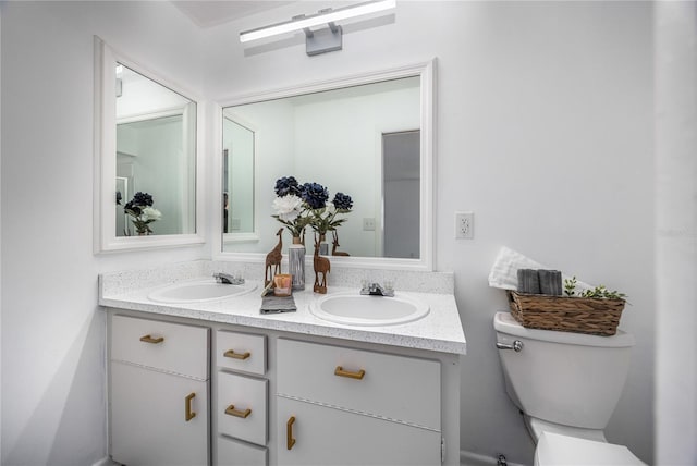 bathroom with toilet and vanity