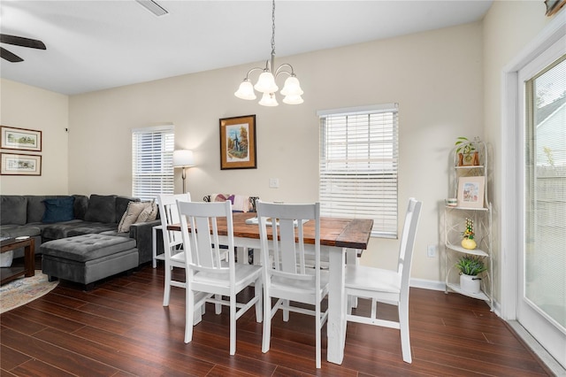 dining space with ceiling fan with notable chandelier