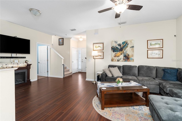 living room featuring dark hardwood / wood-style flooring and ceiling fan