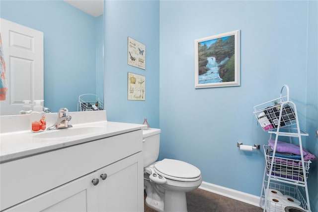 bathroom featuring vanity, toilet, and tile patterned flooring