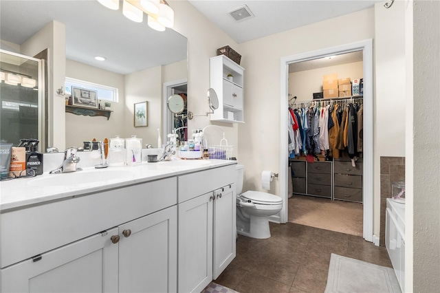 full bathroom with independent shower and bath, vanity, tile patterned floors, and toilet