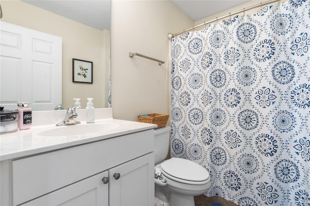 bathroom featuring vanity, toilet, and walk in shower