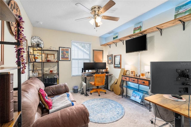 carpeted office featuring ceiling fan