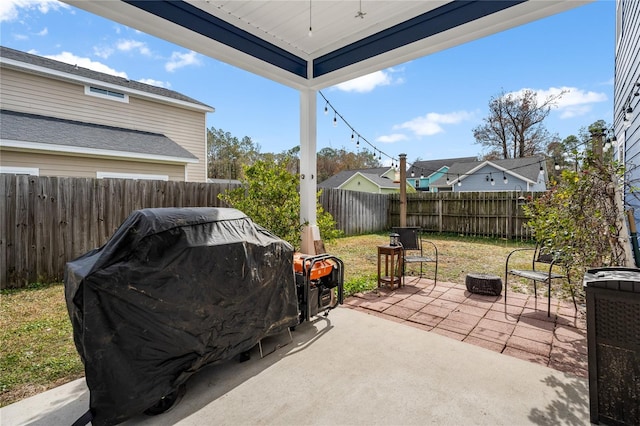 view of patio / terrace with a grill and a fire pit