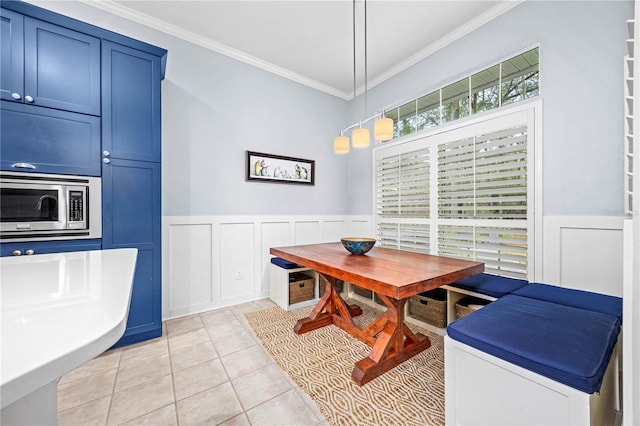 tiled dining room featuring ornamental molding