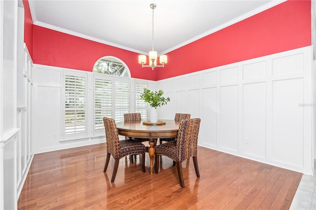 dining area featuring an inviting chandelier, a wealth of natural light, and ornamental molding