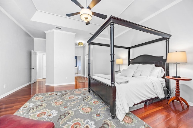 bedroom with ceiling fan, dark hardwood / wood-style floors, and ornamental molding