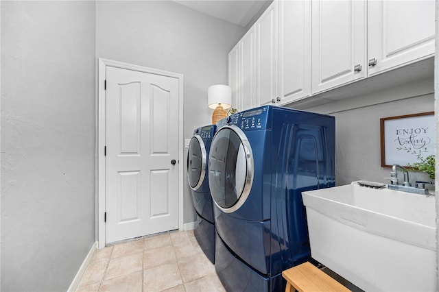 clothes washing area featuring cabinets, light tile patterned flooring, independent washer and dryer, and sink