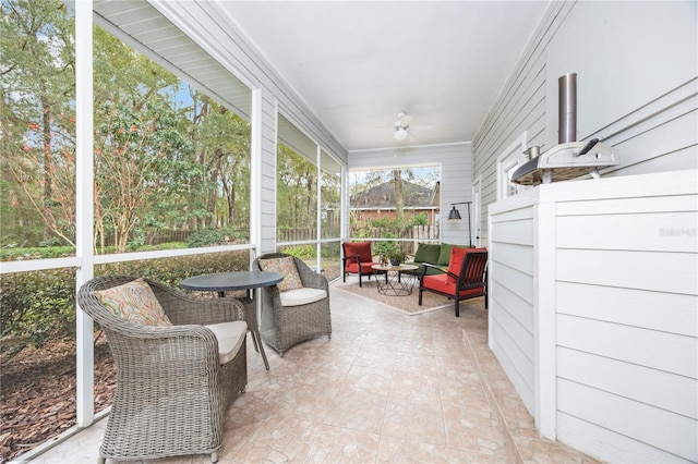 sunroom with ceiling fan