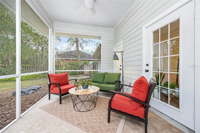 sunroom / solarium featuring ceiling fan