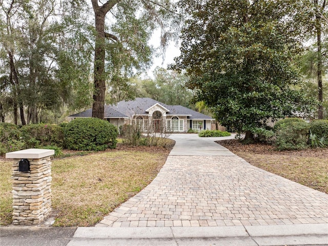 ranch-style house with a front yard