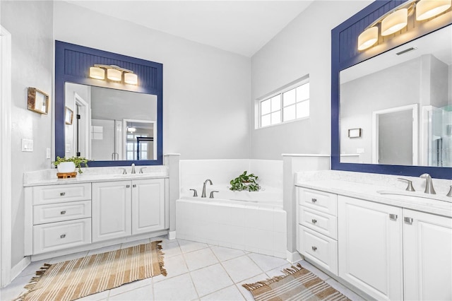 bathroom with vanity, tile patterned floors, and tiled bath