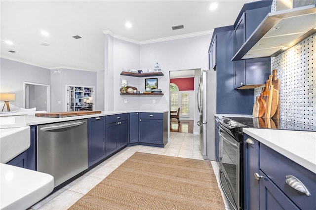 kitchen featuring blue cabinetry, light tile patterned flooring, stainless steel appliances, and wall chimney exhaust hood