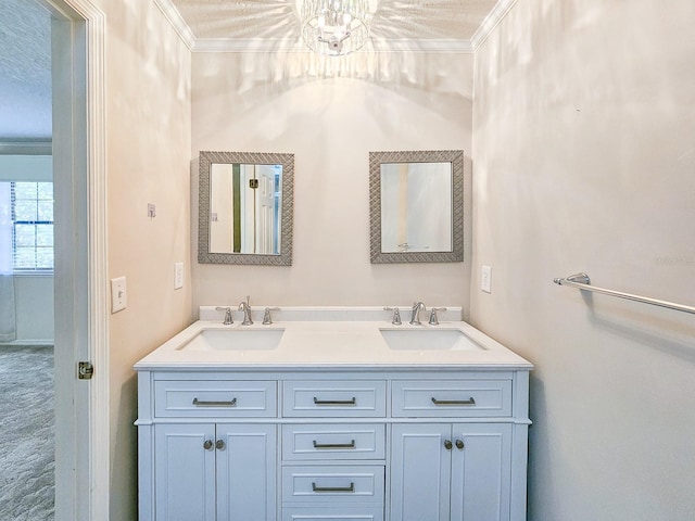 bathroom with a textured ceiling, vanity, and ornamental molding