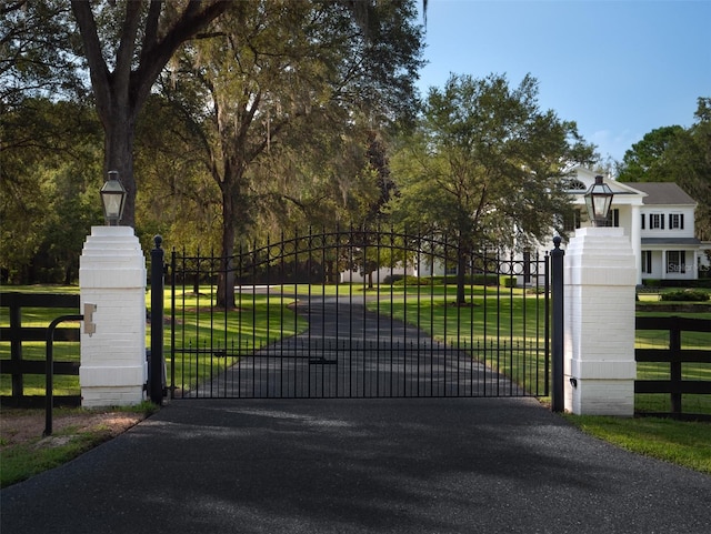 view of gate featuring a yard