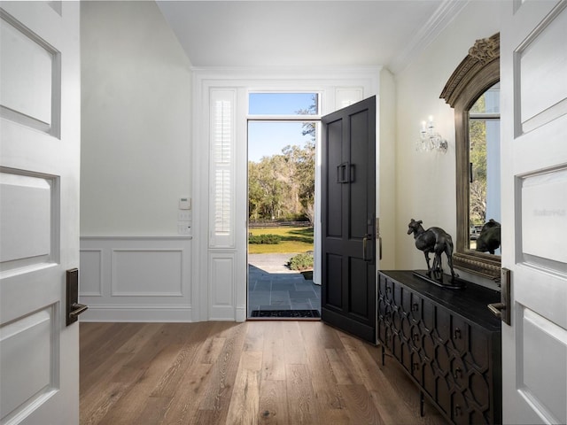 foyer entrance featuring ornamental molding and wood-type flooring