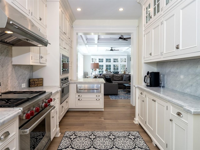 kitchen with light stone counters, ceiling fan, stainless steel appliances, and white cabinets